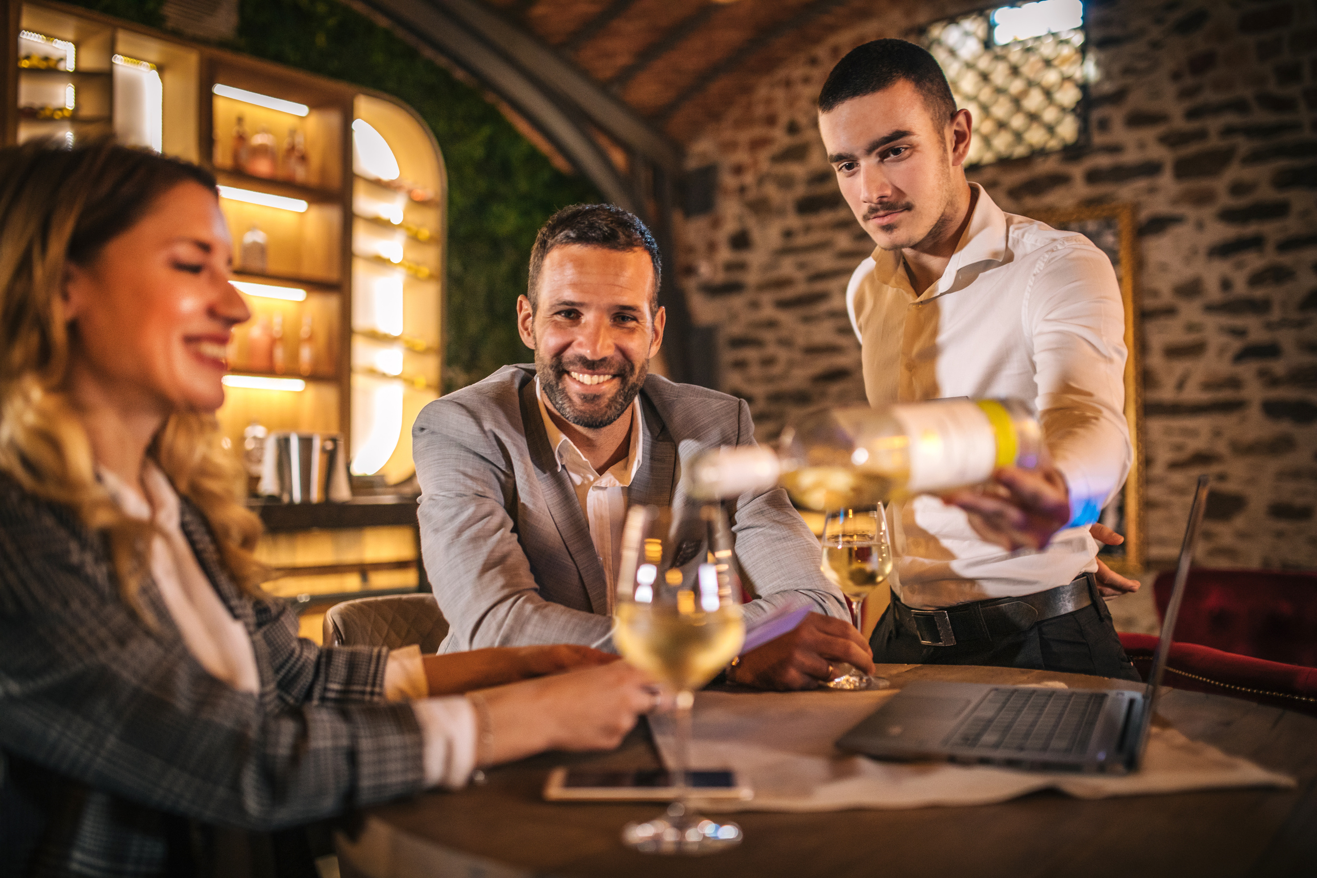 Happy business people toasting in a bar after work